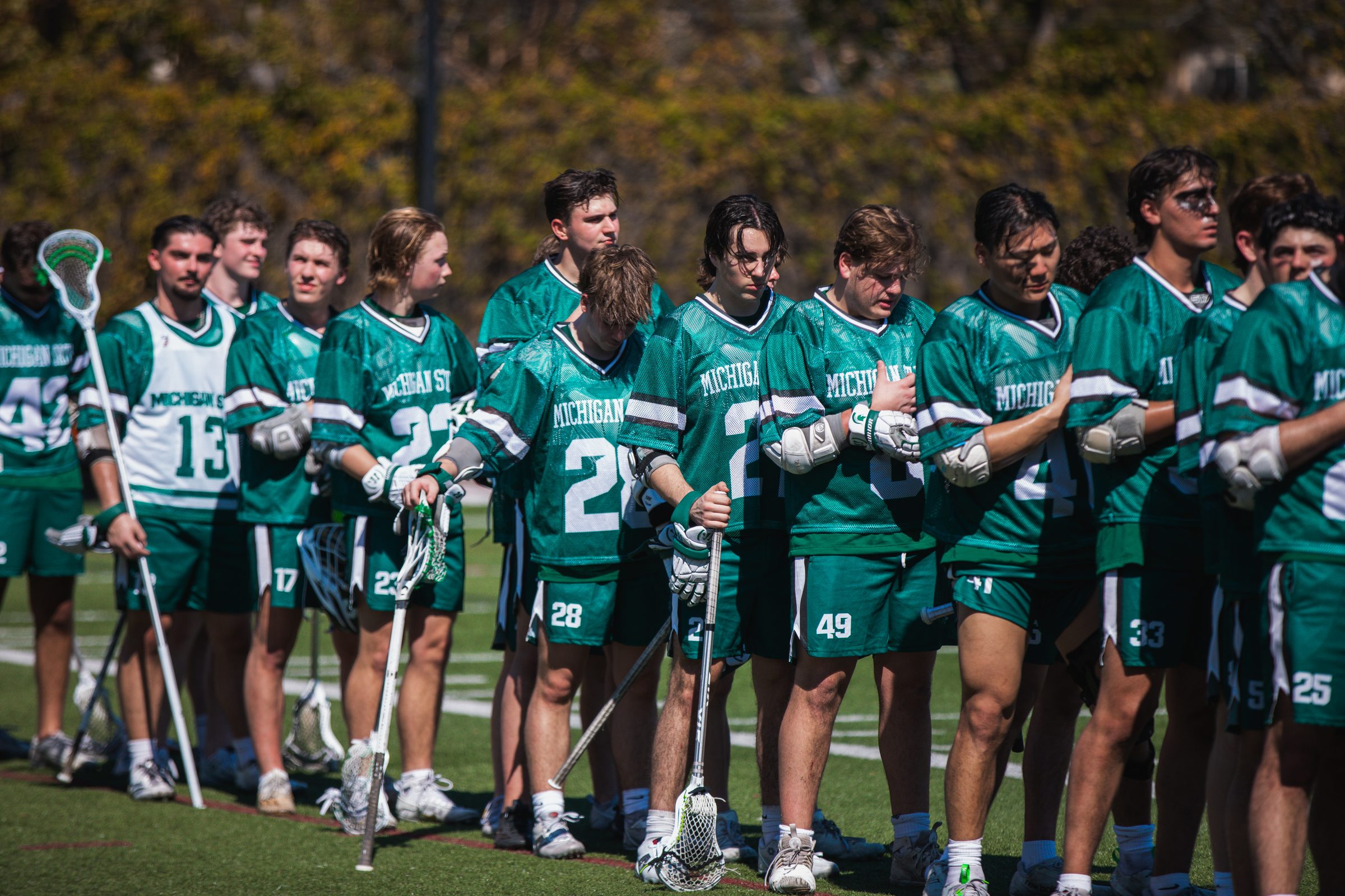 Michigan State lacrosse players lined up on the field