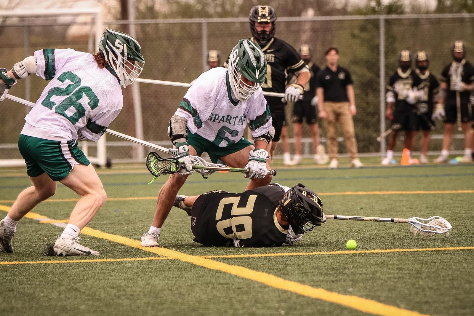 Spartans fighting for a ground ball against Purdue